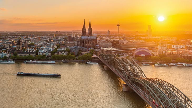 A view over Cologne and the Rhine river at sunset